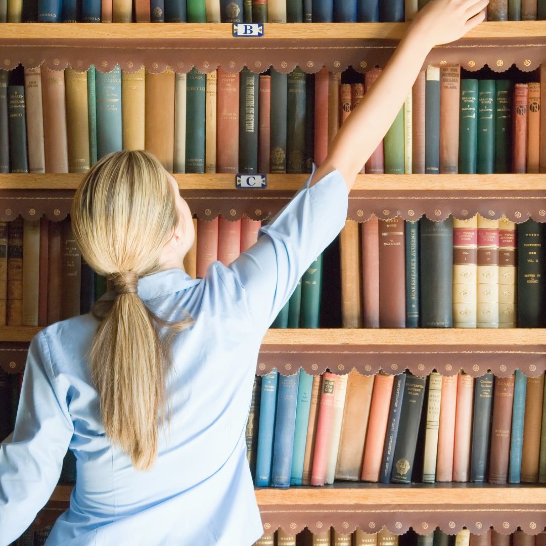 Woman reaching for a book
